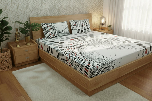 Polka dot bedspread with pillows on a bed in a bedroom setting.