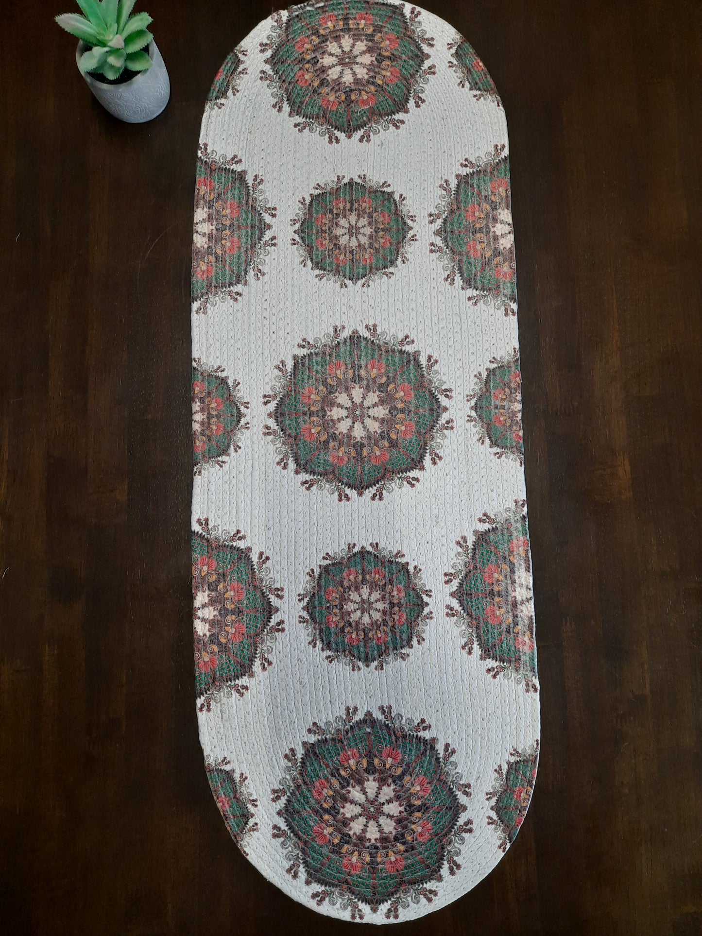 Decorative table runner with geometric pattern on a wooden surface